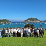 Participants of the summer school on the lawn of Miramar Palace, with La Concha bay behind them